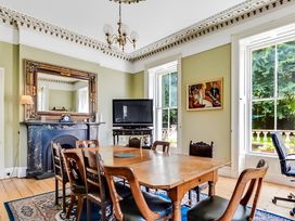 A dining room with a table and chairs at Fountain Hill House in Londonderry