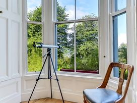 A study with a telescope and chair at Fountain Hill House Londonderry