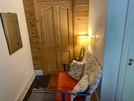 A hallway with a sofa and lamp at Fountain Hill House in Londonderry