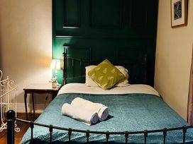 A bedroom with a bed and bedside table at Fountain Hill House Londonderry