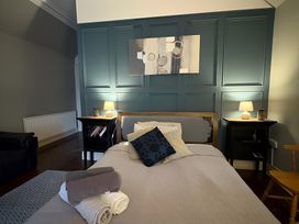A bedroom with a bed and nightstands at Fountain Hill House in Londonderry