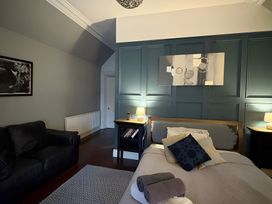 A bedroom with a bed and sofa at Fountain Hill House in Londonderry