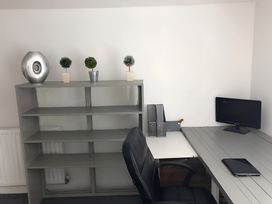 An office with a desk, computer monitor, and decorative plants at Fountain Hill House Londonderry