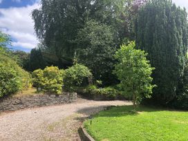 A garden with trees and a gravel pathway at Fountain Hill House Londonderry