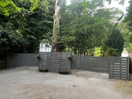 An outdoor area with a gray fence and flower pots at Fountain Hill House Londonderry