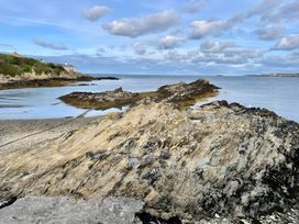 A shore with rocks and water at Bluebell Shepherd’s Hut in Llanfairpwllgwyngyll