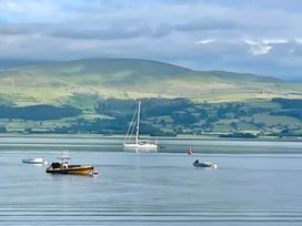 A view of boats on water with hills in the background at Bluebell Shepherd’s Hut in Llanfairpwllgwyngyll