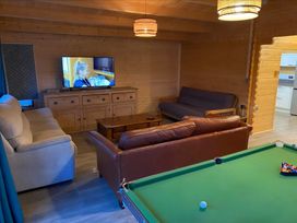 A snug with a pool table and television at Cotswold Nights Evesham