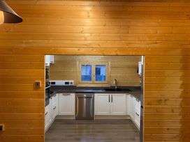 A kitchen with cabinets, a countertop, and a sink at Cotswold Nights in Evesham