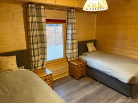 A bedroom with two beds and a window at Cotswold Nights in Evesham