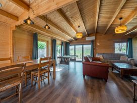A living room with a dining table and a sofa at Cotswold Nights Ashton Under Hill
