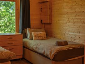 A bedroom with a bed and a window at Cotswold Nights in Ashton Under Hill