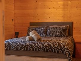 A bedroom with a bed and pillows at Cotswold Nights in Ashton Under Hill
