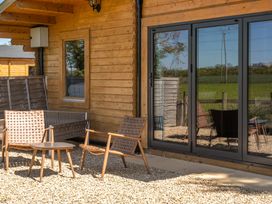 An outdoor seating area with chairs and table at Cotswold Nights Ashton Under Hill