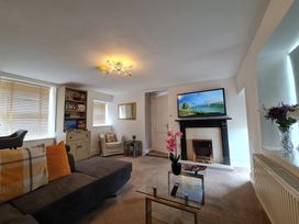 A living room with a sofa and a television at Sea view cottage in Penmaenmawr