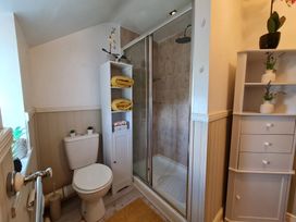 A bathroom with a shower and toilet at Sea view cottage in Penmaenmawr