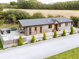 A house with decking and hot tub at Hedgehog Lodge York