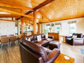 A living room with sofas and a dining area at Hedgehog Lodge in York