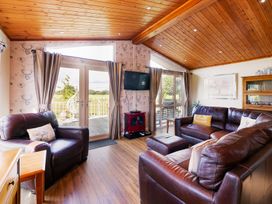 A living room with a television and seating at Hedgehog Lodge in York