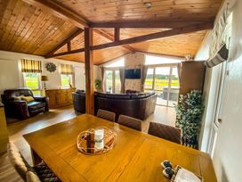 A living room with a dining table and chairs at Hedgehog Lodge in York