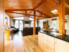 A living room with a sofa and TV at Hedgehog Lodge in York