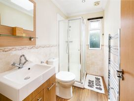 A bathroom with a shower, sink, and toilet at Hedgehog Lodge, York