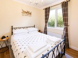 A bedroom with a bed and window at Hedgehog Lodge in York