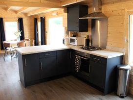 A kitchen with cabinets and appliances at Cotswold Nights Away in Evesham