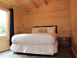 A bedroom with a bed and nightstand at Cotswold Nights Away Evesham