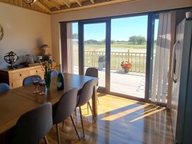 A dining room with a table and chairs at Fox Lodge in York