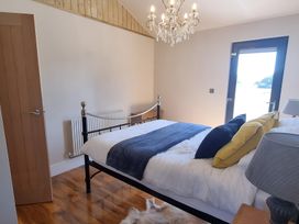 A bedroom with a bed and a chandelier at Fox Lodge in York