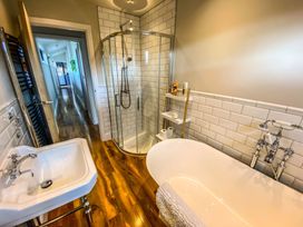 A bathroom with a bathtub and shower at Fox Lodge in York