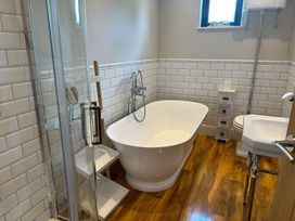 A bathroom with a bathtub and shower at Fox Lodge in York