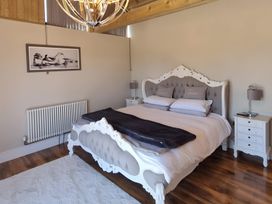 A bedroom with a bed and nightstands at Fox Lodge York