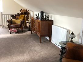A living room with a sofa and ornate chair at Country Retreat Sleeps 2 Holyhead
