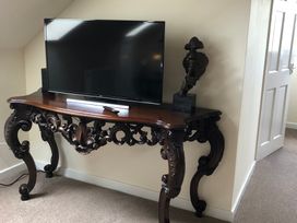 A living room with a television on a console table at Country Retreat Sleeps 2 Holyhead