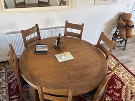 A dining table with chairs and decor at Country Retreat Sleeps 2 in Holyhead