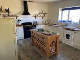 A kitchen with appliances and a central island at Country Retreat Sleeps 2 Holyhead