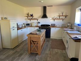 A kitchen with refrigerator, oven, and kitchen island at Country Retreat Sleeps 2 Holyhead