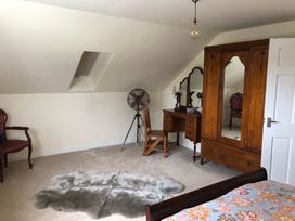 A bedroom with a bed and a dresser at Country Retreat Sleeps 2 Holyhead