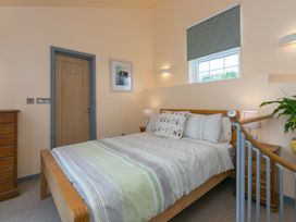 A bedroom with a bed and bedside tables at The Old Well House in Redruth