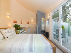 A bedroom with a bed and plant at The Old Well House in Redruth