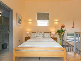 A bedroom with a bed and nightstands at The Old Well House in Redruth