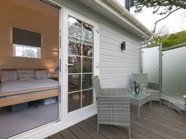 A balcony with furniture outside a bedroom at The Old Well House in Redruth