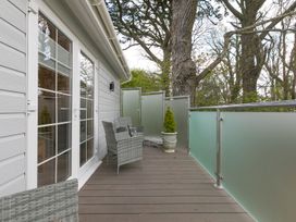 A balcony with chairs and a planter at The Old Well House in Redruth