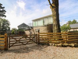 An outdoor area with a tree and spiral staircase at The Old Well House in Redruth
