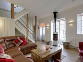 A living room with a sofa and a fireplace at Poppyfields Stable in Redruth