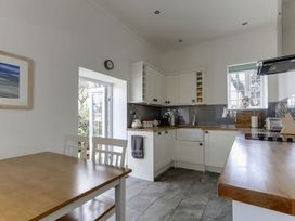 A kitchen with a table and chairs at Poppyfields Stable Redruth