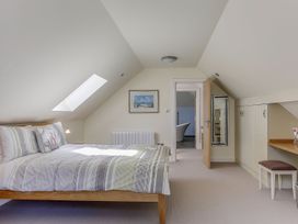 A bedroom with a bed and radiator at Poppyfields Stable in Redruth