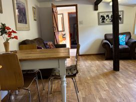 A dining area with a table and chairs at 2 Bed Barn Barroway Drove near Downham Market